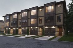 an artist's rendering of the exterior of a three - story apartment building at dusk