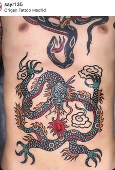 a man's back with tattoos on it and an image of a dragon in the middle