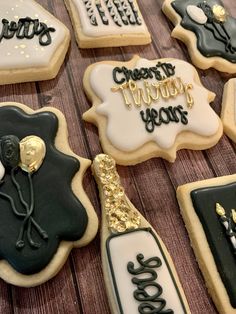 decorated cookies with black and white frosting on a table