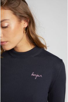 a woman with her eyes closed wearing a black sweater that says bonmpier on it