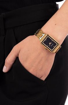 A sleek, instant classic, this deco-inspired bracelet watch features a rectangular framed case and four pyramid markers on the black dial. 25mm x  33mm case; 16mm band width Swiss quartz movement Antireflective sapphire crystal face Stainless steel with PVD Swiss made Black And Gold Watch Women, Balmain Watch, Dove Bracelet, Black And Gold Watch, Gold Watches Women, Bracelet Watches Women, Latest Watches, Black Rectangle, Gold Bracelet For Women