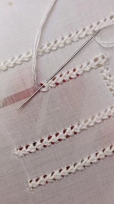 a close up of a piece of cloth with thread and scissors on top of it