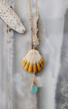 "Sunrise shells are only found in Hawaii. They are extremely rare and sacred. Their name comes from the beautiful colors which reflect a Hawaiian sunrise. This necklace has a gold filled wire wrapped sunrise shell that hangs on a gold filled cable chain. A aqua chalcedony gemstone hangs sweetly below the shell. The shell and gemstone hang 1 7/8\" from the 18\" chain. Made with love by Anna Keay Be sure to check Anna's Sunrise Shell Jewelry Bar every Wednesday at Kai Pua Gallery in Lahaina, Maui. Bohemian Wire Wrapped Chalcedony Jewelry, Ocean-inspired Gold Jewelry With Natural Stones, Bohemian Chalcedony Wire Wrapped Jewelry, Wire Wrapped Shell Jewelry With Ocean-inspired Style, Ocean-inspired Shell Jewelry With Wire Wrapped Detail, Ocean-inspired Shell Jewelry With Wire Wrapping, Ocean-inspired Shell Jewelry Wire Wrapped, Ocean-inspired Shell Wire Wrapped Jewelry, Bohemian Wire Wrapped Shell Jewelry