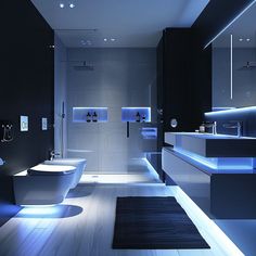 Modern bathroom with ambient blue lighting, clean lines, minimalist design, and futuristic LED lights for a tranquil and luxurious atmosphere Sophisticated Bathroom, Dark Floors, Modern Bathroom Design, Led Lighting, Tron, Modern Bathroom, Clean Lines, Floor Mats