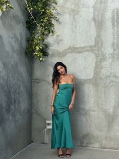 Emerald Waters Strapless Maxi Dress Dive into the deep allure of the coast with this silky emerald green maxi dress. The strapless design is elevated by subtle, pleated detailing across the bodice, creating a perfect blend of elegance and ease. Whether you're walking on the sand or dancing under the stars, this dress f Green Ruched Maxi Dress For Gala, Green Ruched Evening Maxi Dress, Green Ruched Maxi Dress For Prom, Green Strapless Evening Dress For Prom, Green Ruched Bodice Maxi Dress For Gala, Green Strapless Dress For Prom Evening, Green Strapless Dress For Prom, Green Maxi Dress With Ruched Bodice For Gala, Green Prom Dress With Straight Neckline