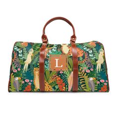 "This personalized travel bag is all about style. Made with high-grade waterproof fabric, it's a highly durable means of transferring your essentials wherever you go. With a resilient carrying handle and an adjustable shoulder strap, it's the perfect companion for all your adventures.  Customize with your Initial or get the best gift for a best friend! With a super cute bright Jungle Style print - this bag is sure to make anyone happy!  .: High-grade nylon material .: Microfiber PU leather top handle and binding .: One size: 20\" × 12'' × 9\" (50.8cm × 30.5cm × 23cm ) .: Brown PU leather handles and an adjustable shoulder strap .: Polyester lining .: Gold-colored zipper Please note* this item is designed by me and produced with the help of a production partner. This item is produced and wi Monogrammed Duffle Bag, Jungle Style, Personalized Travel Bag, Carry On Travel, Waterproof Travel Bag, Jungle Print, Vegan Leather Bag, Travel Duffel, Duffel Bag Travel