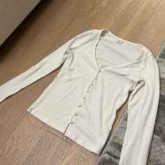 Aritzia Pearl Button Tight Long Sleeve Shirt. So Cute On But Was A Little Too Tight On Me. Never Worn!! White Stretch Button-up Top, White Stretch Top With Button Closure, White Stretch Tops With Button Closure, Fitted Long Sleeve Tops With Buttons, Stretch Long Sleeve Tops With Button Closure, Fitted Long Sleeve Tops With Button Closure, Trendy White Top With Snap Buttons, Trendy Fitted Shirt With Buttons, Fitted Button-up Top For Day Out