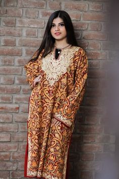 A stunningly marvellous Pheran. This Pheran features intricate Kashmir Aari embroidery on all-over the front side and on the sleeves.- - - - - - - - - - - - - - - - - - - - Product Details- Condition: Brand New (made to order)- Style: Phiran Tunic- Fabric: Pure Wool- Colour: Red- Embroidery: Jaal Aari Work- Embroidery Colour: Multi-Colour- Standard Length: 40" | Can be customized- Care Instructions: Dry Clean Only.**If you want the Tunic to be shorter or longer, just send us a message, and we wi Bohemian Semi-stitched Kaftan With Resham Embroidery, Bohemian Kaftan With Resham Embroidery Semi-stitched, Festive Multicolor Kaftan With Zari Work, Wedding Kaftan With Intricate Embroidery For Navratri, Traditional Drape Kaftan With Intricate Embroidery For Diwali, Intricate Embroidery Kaftan For Diwali With Traditional Drape, Traditional Kaftan With Intricate Embroidery For Diwali, Bollywood Style Dabka Kaftan For Traditional Ceremonies, Festive Motifs Kaftan