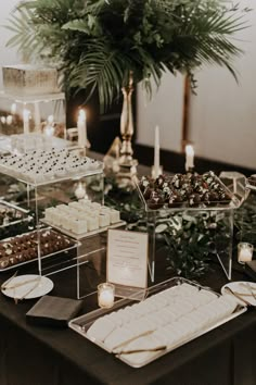 a table topped with lots of desserts and candles