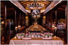 a long table is set up with flowers and candles for a wedding reception at the lodge