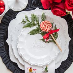 a white plate topped with candy canes on top of a black and white table