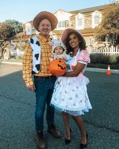 a man and woman dressed up in costumes for halloween with a baby on her lap