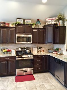 a kitchen with brown cabinets and stainless steel appliances