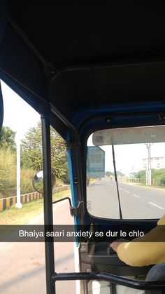 a man driving a bus down a street next to a road with traffic signs on it