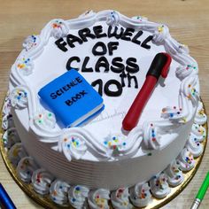 a cake with the words farewell of class on it and a book next to it