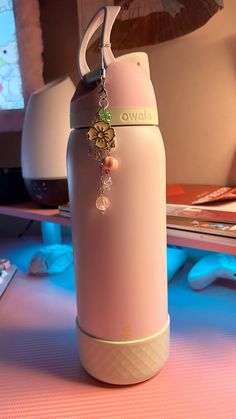 a pink water bottle sitting on top of a table