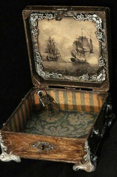 an old wooden box with a painting on it's lid that is open to reveal the inside