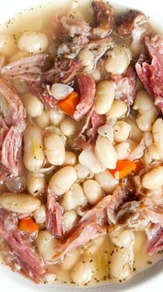 white bean soup with ham and carrots in a bowl