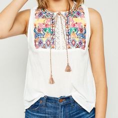 Nwt Hayden White Multi-Color Embroidered Sleeveless Top M A Solid Hued Sleeveless Top Featuring Front Multi-Color Embroidered Details, A Multi-Color Tassel, A Crochet Cutout Detail, And A Rounded Neckline. 100% Cotton New. With. Tag. Bohemian Embroidered Cotton Tank Top, Bohemian Cotton Embroidered Tank Top, Spring Embroidered Sleeveless Vest, Sleeveless Embroidered Spring Vest, Spring Sleeveless Embroidered Vest, Embroidered Sleeveless Vest For Spring, Sleeveless Embroidered Vest For Spring, White Embroidered Summer Vest, Embroidered Cotton Tank Top For Beach