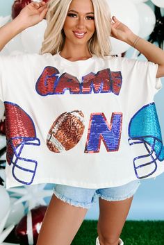 100% COTTON Model Wearing Size Small Color: White, Red, Blue Round Neckline Short, Dolman Sleeves Sequin "Game On" Text With Football & Helmet Graphics Boxy & Oversized Fit 15" Armpit To Hemline For Model Size Specs Please Check Size Charts + Live Feed Notes Below Launched: 8/18/23 Game Day Attire For Women, Diy Shirt Printing, Football Casual Clothing, Helmet Graphics, Game Day Fits, Day Club, Cricut Shirts, Boutique Clothes, Graphic Dress