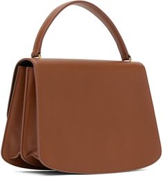 Buffed calfskin top handle bag in brown. · Fixed carry handle · Foldover flap with tab-slot closure · Zip pocket and patch pocket at two-compartment interior · H7.5 x W10 x D3.5 in Supplier color: Tawny Designer Brown Flap Bag With Top Handle, Designer Brown Top Handle Flap Bag, Brown Calf Leather Top Handle Satchel, Classic Brown Satchel With Round Handle, Modern Brown Flap Bag With Top Handle, Brown Office Satchel With Round Handle, Brown Office Bag With Round Handle, Brown Calf Leather Satchel With Top Carry Handle, Brown Bags With Round Handle For Workwear