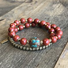 Genuine red jasper 27 bead wrist mala bracelet, hand made brass African Trade beads and a limited edition hand made Tibetan guru bead. Its a wrap bracelet, (str Red Agate Beaded Bracelets For Meditation, Red Agate Beaded Bracelet For Meditation, Red Agate Bracelets For Meditation, Red Beaded Bracelets With Natural Stones For Meditation, Red Gemstone Beads Bracelets For Meditation, Red Spiritual Beaded Bracelets With Natural Stones, Spiritual Red Beaded Bracelets With Natural Stones, Jasper Beaded Bracelets For Gifts, Red Coral Gemstone Beads Bracelets