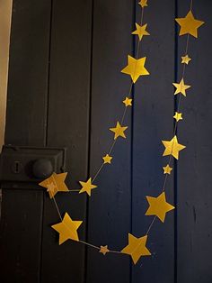 a string of yellow stars hanging from the side of a door