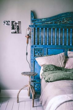 a blue headboard and foot stool in a bedroom