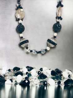 Indulge in the allure of bygone eras with our Vintage-Looking Black and White Costume Jewelry Necklaces. This necklace brings a touch of nostalgia and classic charm to your modern style, making it a must-have for lovers of vintage aesthetics.  With its vintage-inspired design and classic color palette, this necklace is the perfect accessory to transform any outfit into a masterpiece of timeless beauty. Whether you're attending a themed event or simply adding a touch of vintage charm to your dail Elegant Beaded Crystal Necklaces For Evening, Elegant Beaded Crystal Necklace For Evening, Elegant Large Beads Bracelets For Party, Elegant Large Beads Bracelet For Party, Elegant Large Beaded Bracelets For Party, Handmade Necklaces With Round Beads For Evening, Handmade Evening Necklace With Round Beads, Elegant Party Bracelets With Large Beads, Vintage Crystal Necklaces For Party