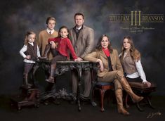 a family posing for a portrait in front of a black background with the words william and branon on it