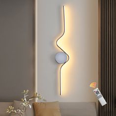 a living room scene with focus on the wall light and remote control in the foreground