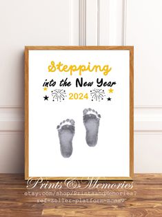 a baby's new year print with the words stepping into the new year and two feet