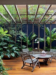 a screen shot of an outdoor dining area with plants and trees in the background, on instagram