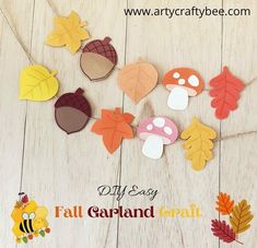 fall garland made out of felt leaves and acorns on a wooden floor with text overlay that says diy easy fall garland craft