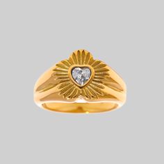 This flower-shaped signet ring features a dazzling heart-shaped cubic zirconia, surrounded by an outburst design. Ideal to wear... 24/7! Wear solo or with multiple rings. Regardless of what you do, one thing is certain: this is a high-quality dazzling ring you can wear daily! Details Material: Stainless Steel dipped in 18k gold Waterproof and Tarnish Free Stone: Cubic Zirconia Please note we do not guarantee the tone of any of our gold items will match as it can vary from batch to batch. Heart Signet Ring, Gold Items, Multiple Rings, Freshwater Pearl Jewelry, Ring Heart, Chunky Rings, Sacred Heart, Signet Ring, Gold Plated Jewelry