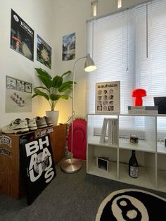 a room with various items on the floor and a plant in the corner next to it