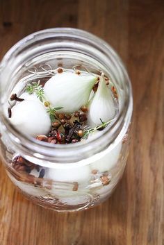 a glass jar filled with food on top of a wooden table