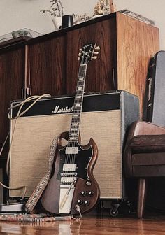 an electric guitar and amp sitting on the floor