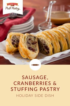 sausage, cranberries and stuffing pastry on a plate with wine glasses in the background