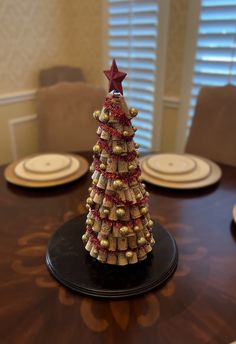 a christmas tree made out of wine corks sitting on top of a wooden table