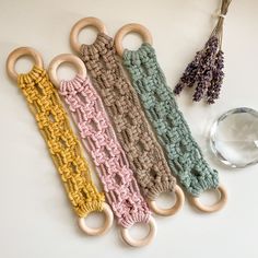 three crocheted scissors are sitting next to each other on a white surface with lavenders