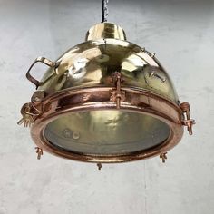 an antique brass light fixture hanging from a ceiling