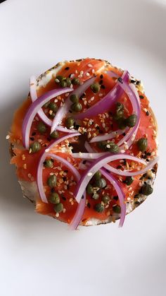 an open face sandwich topped with onions and capers