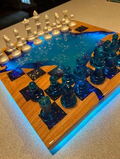 a chess board with blue glass pieces on it