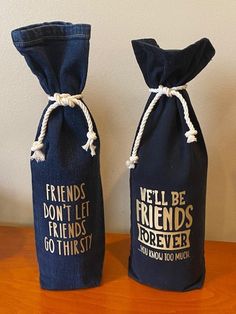 two wine bags with the words friends don't let friends go thirsty on them