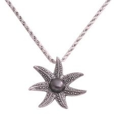 Centered by a black cultured pearl a sterling silver starfish spreads its limbs in the pendant of this necklace. Desi Antari designs the necklace circling the neck on a sterling rope chain. Desi names the necklace Galang a Balinese word that means shining. Elegant Silver Starfish Jewelry, Elegant Silver Starfish Necklace, Desi Names, Starfish Necklace, Silver 925 Necklace, Freshwater Cultured Pearls, Pearl Pendant Necklace, Balinese, Jewelry Packaging