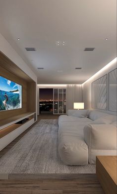 a large white bed sitting in a bedroom next to a tv mounted on a wall