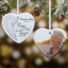 two heart shaped ornaments hanging from a christmas tree