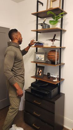 a man standing in front of a book shelf