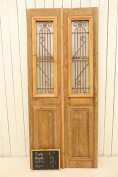 an old wooden door with a chalkboard on the front and side panels that have been made to look like wood